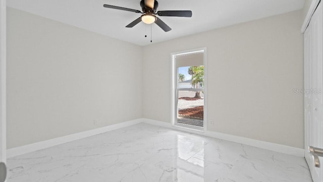 1024 Spindle Palm Way, Apollo Beach, FL 33572 - empty room with marble finish floors, baseboards, and a ceiling fan