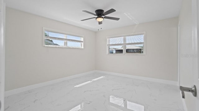 1024 Spindle Palm Way, Apollo Beach, FL 33572 - empty room featuring marble finish floors, baseboards, and a ceiling fan