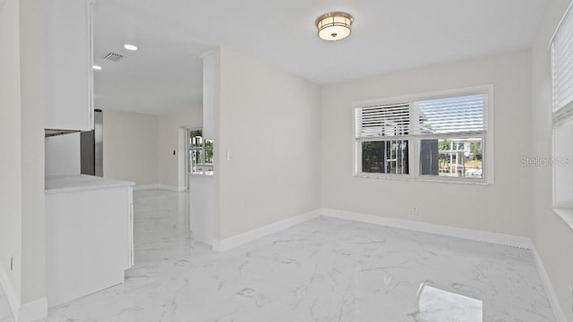 1024 Spindle Palm Way, Apollo Beach, FL 33572 - spare room with healthy amount of natural light, light marble finish flooring, baseboards, and recessed lighting