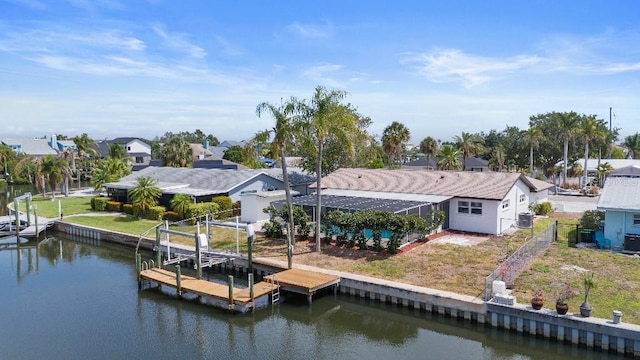 1024 Spindle Palm Way, Apollo Beach, FL 33572 - dock featuring a water view, central AC, glass enclosure, a residential view, and boat lift
