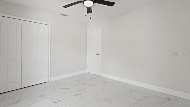 1024 Spindle Palm Way, Apollo Beach, FL 33572 - unfurnished bedroom featuring marble finish floors, baseboards, a closet, and ceiling fan