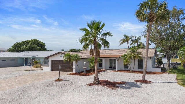 1024 Spindle Palm Way, Apollo Beach, FL 33572 - ranch-style house with an attached garage, stucco siding, and driveway