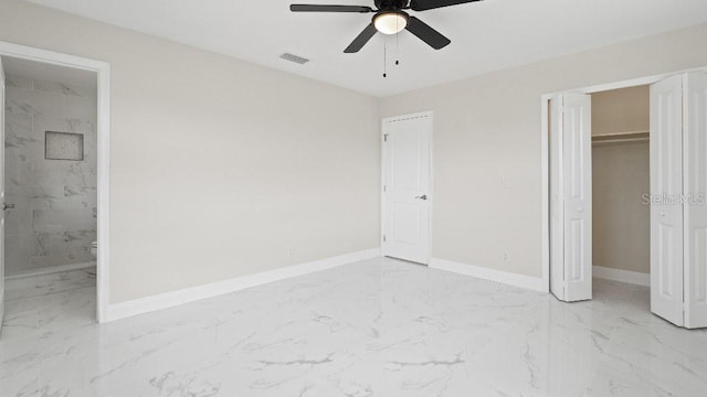 1024 Spindle Palm Way, Apollo Beach, FL 33572 - unfurnished bedroom featuring light marble finish floors, baseboards, a closet, and ensuite bath