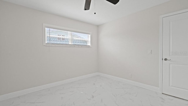 1024 Spindle Palm Way, Apollo Beach, FL 33572 - spare room with light marble finish floors, a ceiling fan, and baseboards
