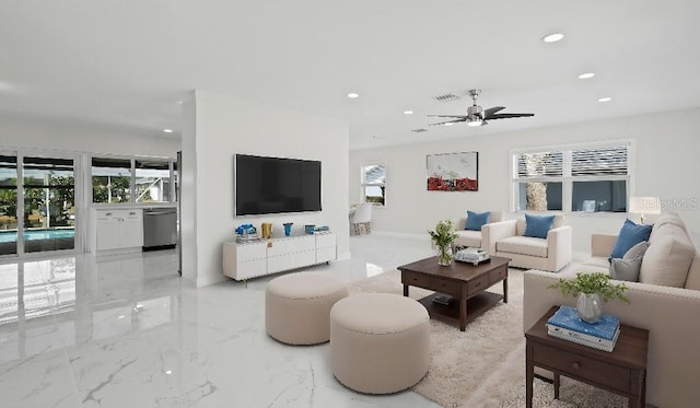 1024 Spindle Palm Way, Apollo Beach, FL 33572 - living room with recessed lighting, light marble finish flooring, ceiling fan, and baseboards