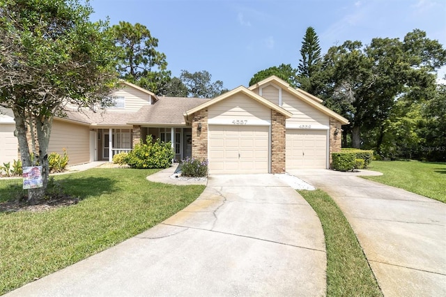 4557 Glen Holw, New Port Richey, FL 34653 - view of front of home with brick siding, a front yard, an attached garage, and concrete driveway