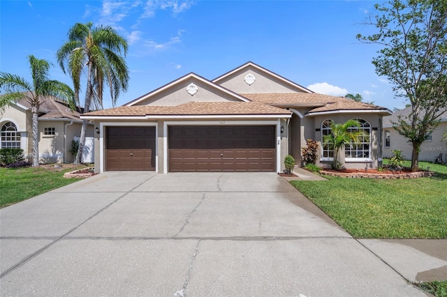 1862 Wood Bend St, Tarpon Springs, FL 34689 - ranch-style home with a garage, stucco siding, a front yard, and driveway
