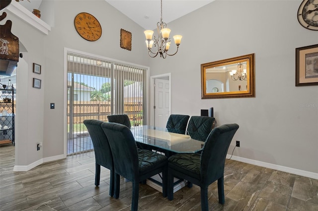 1862 Wood Bend St, Tarpon Springs, FL 34689 - dining space featuring a chandelier, high vaulted ceiling, and baseboards