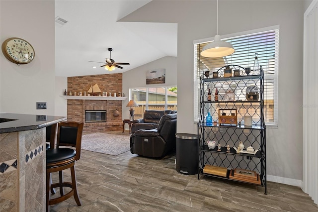 1862 Wood Bend St, Tarpon Springs, FL 34689 - living area featuring a ceiling fan, vaulted ceiling, and a fireplace