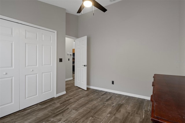1862 Wood Bend St, Tarpon Springs, FL 34689 - unfurnished bedroom with dark wood finished floors, a closet, baseboards, and a ceiling fan
