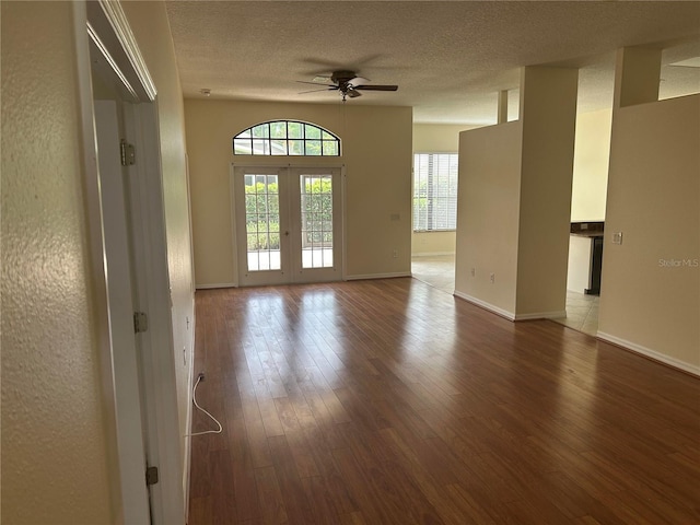 11520 Lounds Ct, New Port Richey, FL 34654 - empty room with ceiling fan, french doors, wood finished floors, a textured ceiling, and baseboards