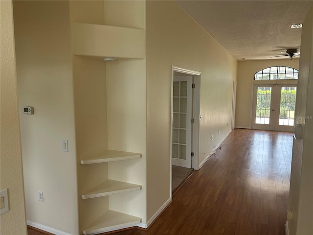 11520 Lounds Ct, New Port Richey, FL 34654 - corridor with french doors, a textured ceiling, dark wood finished floors, and baseboards