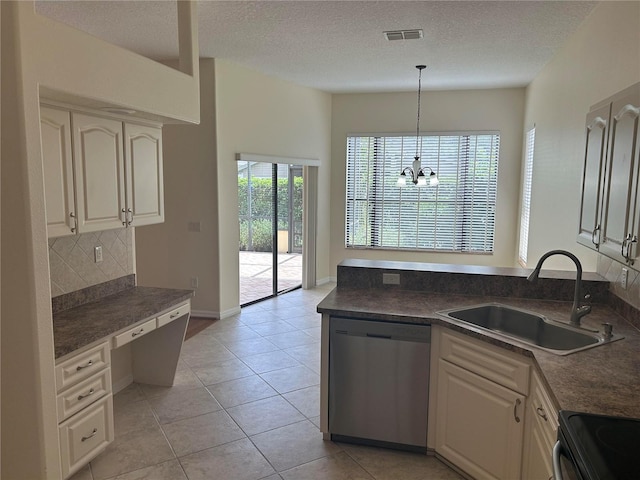11520 Lounds Ct, New Port Richey, FL 34654 - kitchen with dishwasher, a sink, dark countertops, a textured ceiling, and decorative backsplash