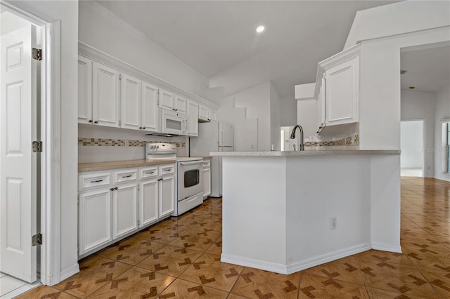 4125 Mc Clung Dr, New Port Richey, FL 34653 - kitchen featuring white appliances, white cabinetry, light countertops, and recessed lighting