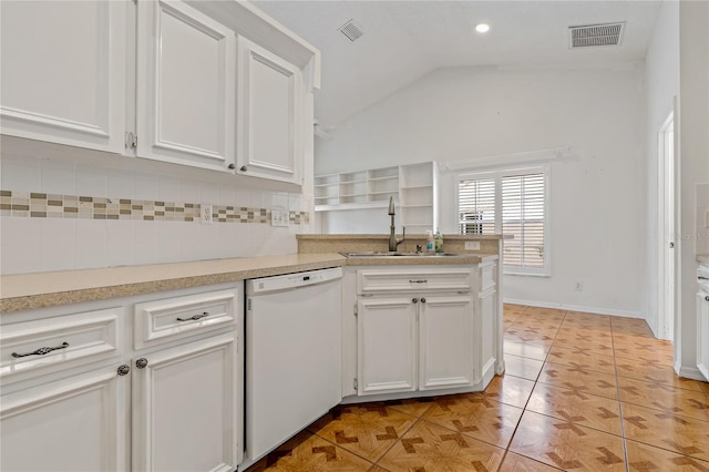 4125 Mc Clung Dr, New Port Richey, FL 34653 - kitchen with white dishwasher, a sink, white cabinetry, decorative backsplash, and vaulted ceiling