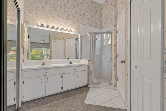 4125 Mc Clung Dr, New Port Richey, FL 34653 - full bath with wallpapered walls, a closet, a shower stall, double vanity, and tile patterned floors