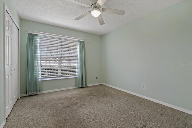 4125 Mc Clung Dr, New Port Richey, FL 34653 - unfurnished bedroom featuring carpet flooring, a textured ceiling, a closet, baseboards, and a ceiling fan