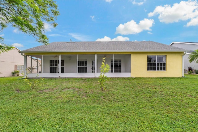 4125 Mc Clung Dr, New Port Richey, FL 34653 - back of house featuring a sunroom, a ceiling fan, a yard, stucco siding, and roof with shingles