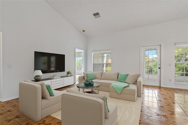 4125 Mc Clung Dr, New Port Richey, FL 34653 - living area featuring plenty of natural light, high vaulted ceiling, and baseboards