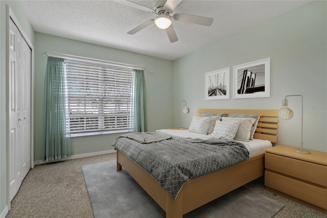 4125 Mc Clung Dr, New Port Richey, FL 34653 - carpeted bedroom with a closet, a textured ceiling, baseboards, and a ceiling fan