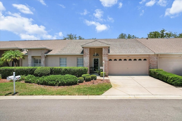 1142 Wolford Dr, Trinity, FL 34655 - ranch-style house featuring a garage, concrete driveway, a shingled roof, stucco siding, and brick siding