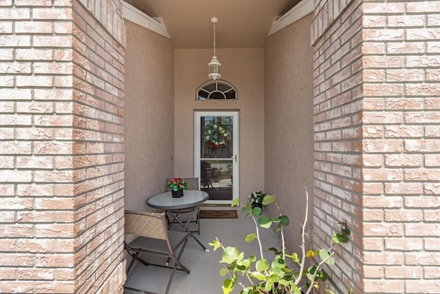 1142 Wolford Dr, Trinity, FL 34655 - property entrance with brick siding, stucco siding, and covered porch