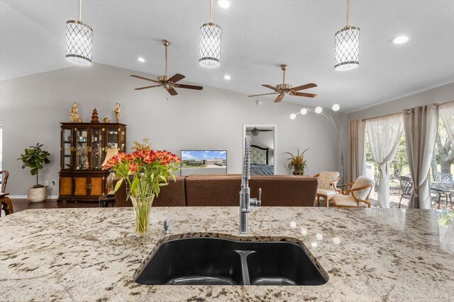 1142 Wolford Dr, Trinity, FL 34655 - kitchen featuring a sink, a ceiling fan, vaulted ceiling, open floor plan, and hanging light fixtures