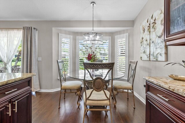 1142 Wolford Dr, Trinity, FL 34655 - dining space featuring baseboards, dark wood-style flooring, and a chandelier