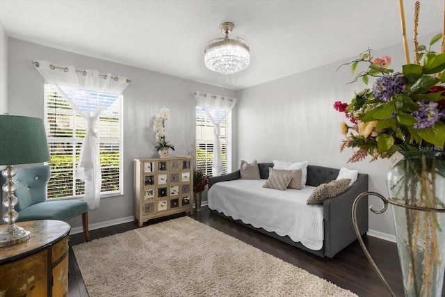 1142 Wolford Dr, Trinity, FL 34655 - bedroom with a chandelier, dark wood-style floors, and baseboards