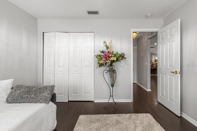 1142 Wolford Dr, Trinity, FL 34655 - bedroom with dark wood-type flooring, baseboards, and a closet
