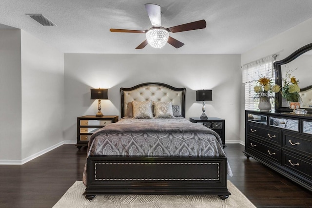 1142 Wolford Dr, Trinity, FL 34655 - bedroom featuring dark wood finished floors, baseboards, a textured ceiling, and ceiling fan