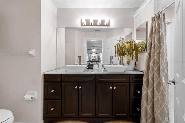 1142 Wolford Dr, Trinity, FL 34655 - bathroom with double vanity, toilet, curtained shower, and baseboards