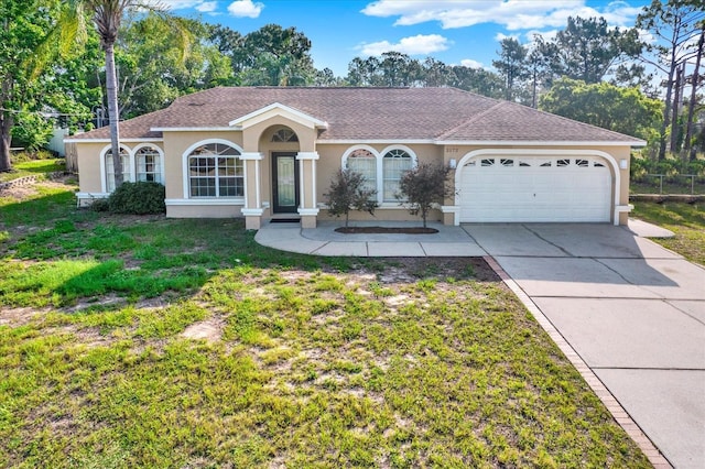 2172 Whitewood Ave, Spring Hill, FL 34609 - view of front facade with an attached garage, driveway, stucco siding, a front lawn, and roof with shingles