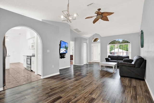 2172 Whitewood Ave, Spring Hill, FL 34609 - living area featuring a ceiling fan, lofted ceiling, arched walkways, wood finished floors, and baseboards