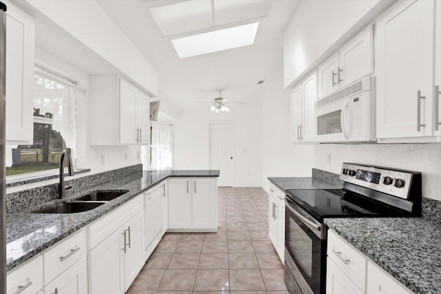 2172 Whitewood Ave, Spring Hill, FL 34609 - kitchen with white appliances, a sink, white cabinets, and light tile patterned floors