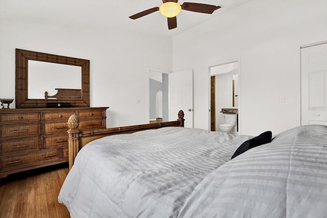 2172 Whitewood Ave, Spring Hill, FL 34609 - bedroom featuring vaulted ceiling, wood finished floors, connected bathroom, and ceiling fan