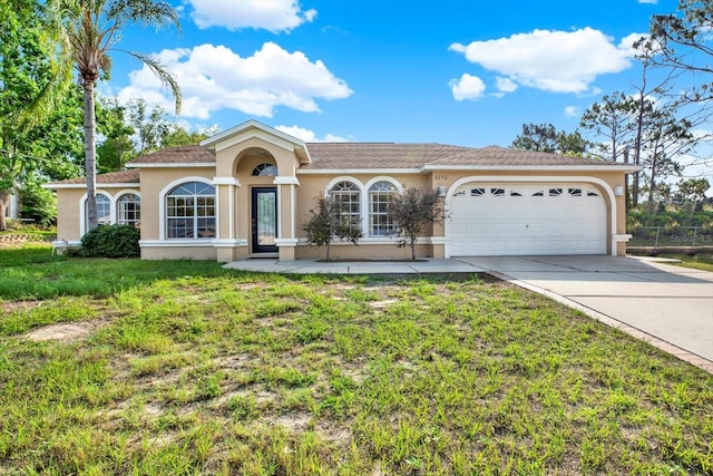 2172 Whitewood Ave, Spring Hill, FL 34609 - view of front of house featuring concrete driveway, stucco siding, an attached garage, and a front yard