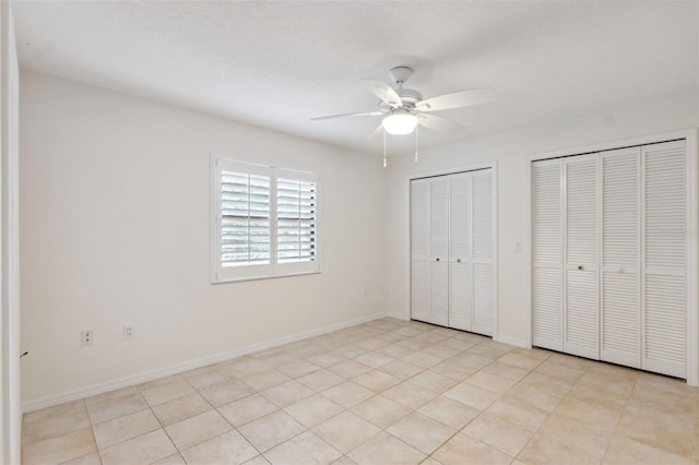 1471 N Jasmine Ave, Tarpon Springs, FL 34689 - unfurnished bedroom with two closets, ceiling fan, and baseboards