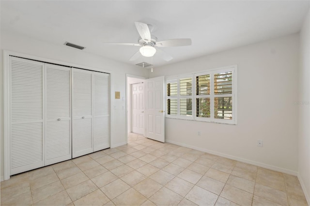 1471 N Jasmine Ave, Tarpon Springs, FL 34689 - unfurnished bedroom featuring a closet, light tile patterned floors, baseboards, and ceiling fan