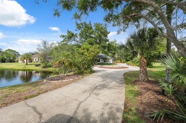 1471 N Jasmine Ave, Tarpon Springs, FL 34689 - view of property's community featuring a water view, a yard, and driveway
