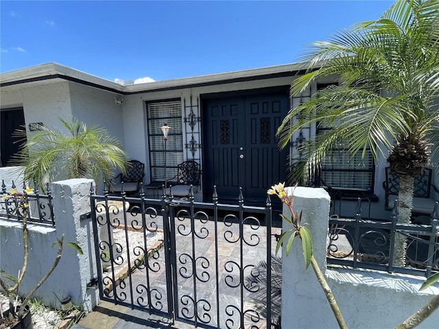 7534 Briarwood Dr, Port Richey, FL 34668 - view of exterior entry with a porch and stucco siding