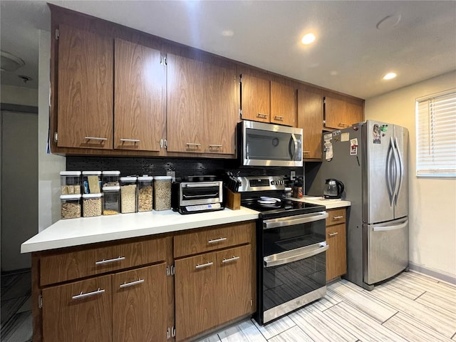 7534 Briarwood Dr, Port Richey, FL 34668 - kitchen with stainless steel appliances, light countertops, brown cabinets, and recessed lighting