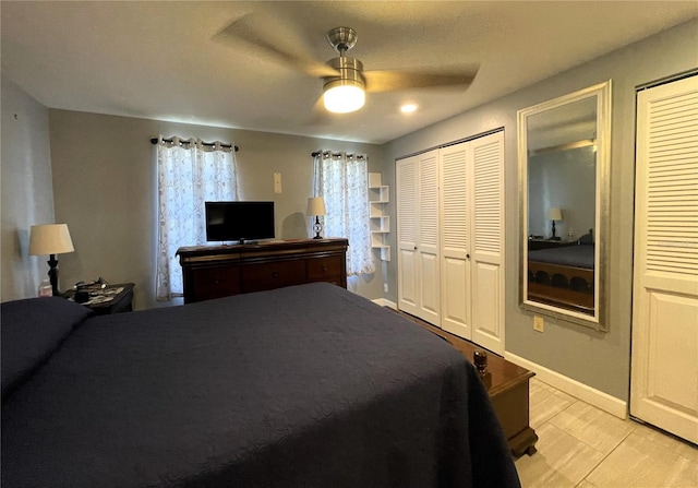 7534 Briarwood Dr, Port Richey, FL 34668 - bedroom featuring two closets, light wood-style flooring, a ceiling fan, and baseboards