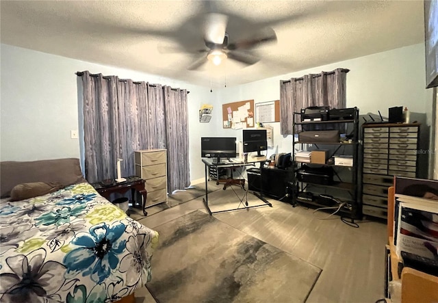7534 Briarwood Dr, Port Richey, FL 34668 - bedroom featuring an office area, wood finished floors, a textured ceiling, and a ceiling fan