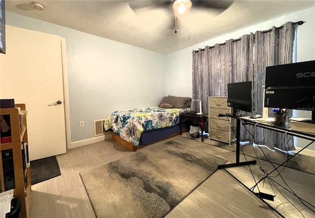 7534 Briarwood Dr, Port Richey, FL 34668 - bedroom with wood finished floors, baseboards, and ceiling fan