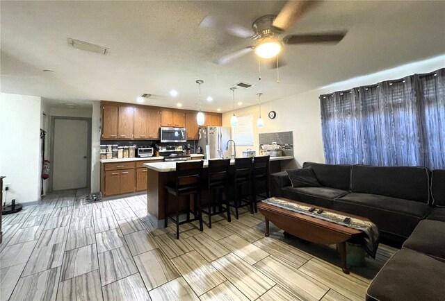 7534 Briarwood Dr, Port Richey, FL 34668 - living room with a ceiling fan, wood tiled floors, and recessed lighting