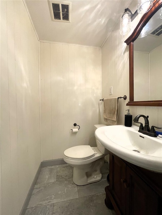 7534 Briarwood Dr, Port Richey, FL 34668 - half bath featuring vanity, toilet, and baseboards
