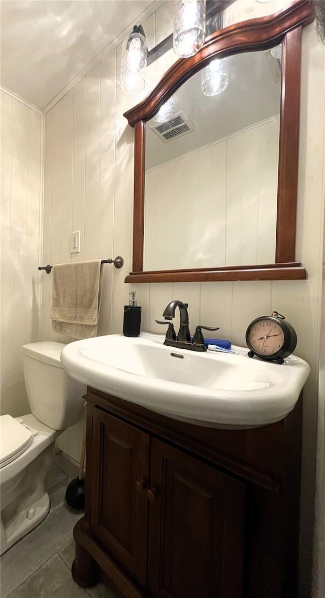 7534 Briarwood Dr, Port Richey, FL 34668 - bathroom featuring vanity, toilet, and tile patterned flooring