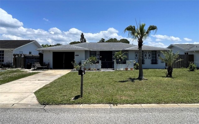 7534 Briarwood Dr, Port Richey, FL 34668 - ranch-style house featuring driveway, an attached garage, and stucco siding