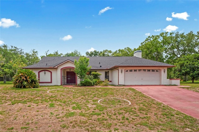 128 Oak Lake Dr, Spring Hill, FL 34608 - ranch-style home with a garage, a chimney, driveway, stucco siding, and a front yard